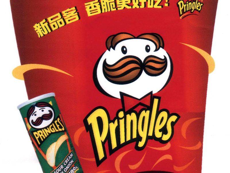 A red in-store display for Pringles with the brand mascot and Mandarin new-product headlines.